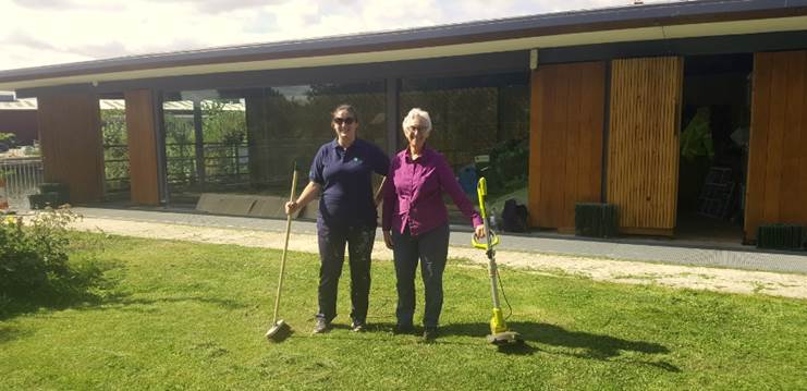 EA volunteer Jemma (left) helped cut the grass at the Osney Lock Hydro, following a guided tour by OLH Director Ruth